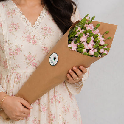 Fresh Spray Carnation blooms bundled in brown paper