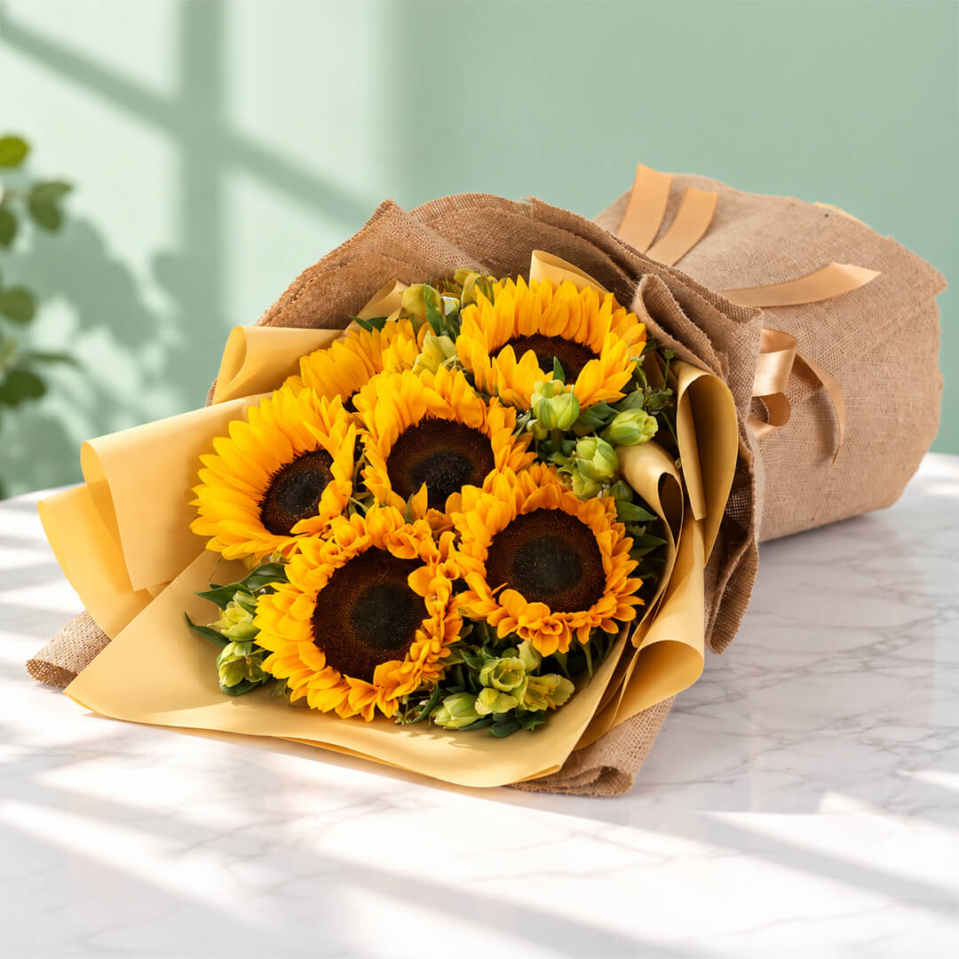 Yellow sunflower and alstroemeria arrangement with layered floral wrapping