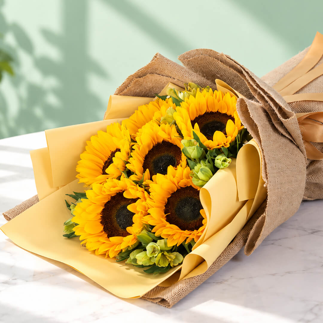 Yellow sunflower and alstroemeria arrangement with layered floral wrapping