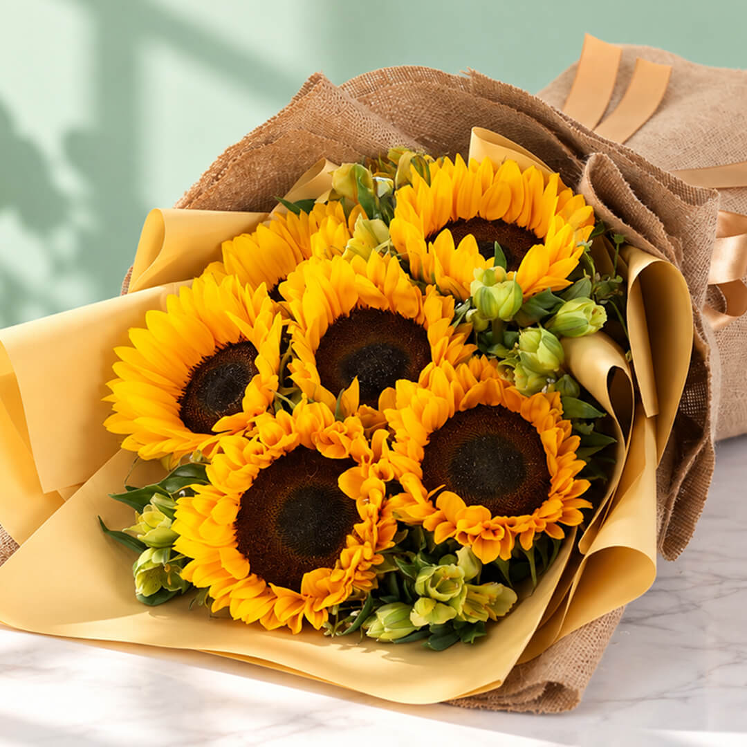 Yellow sunflower and alstroemeria arrangement with layered floral wrapping