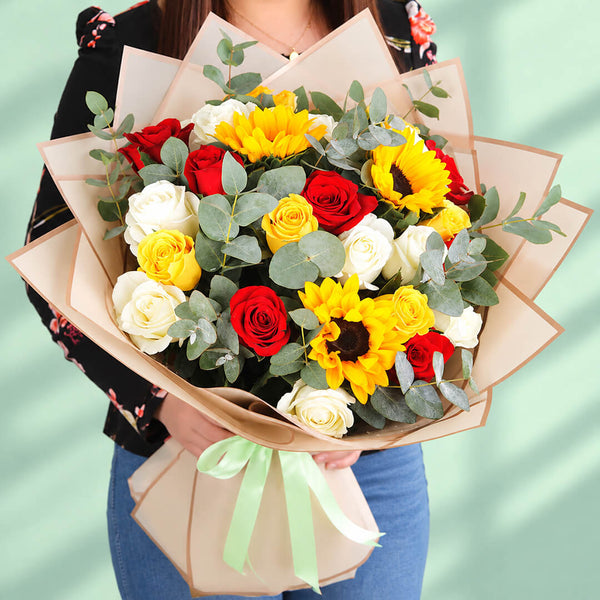 Sunflower, rose, hypericum and eucalyptus bouquet in Korean-style wrapping.