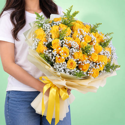 Yellow rose bouquet with gypsophila and non-woven wrapping