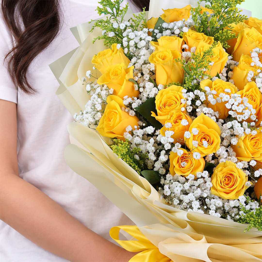 Yellow rose bouquet with gypsophila and non-woven wrapping