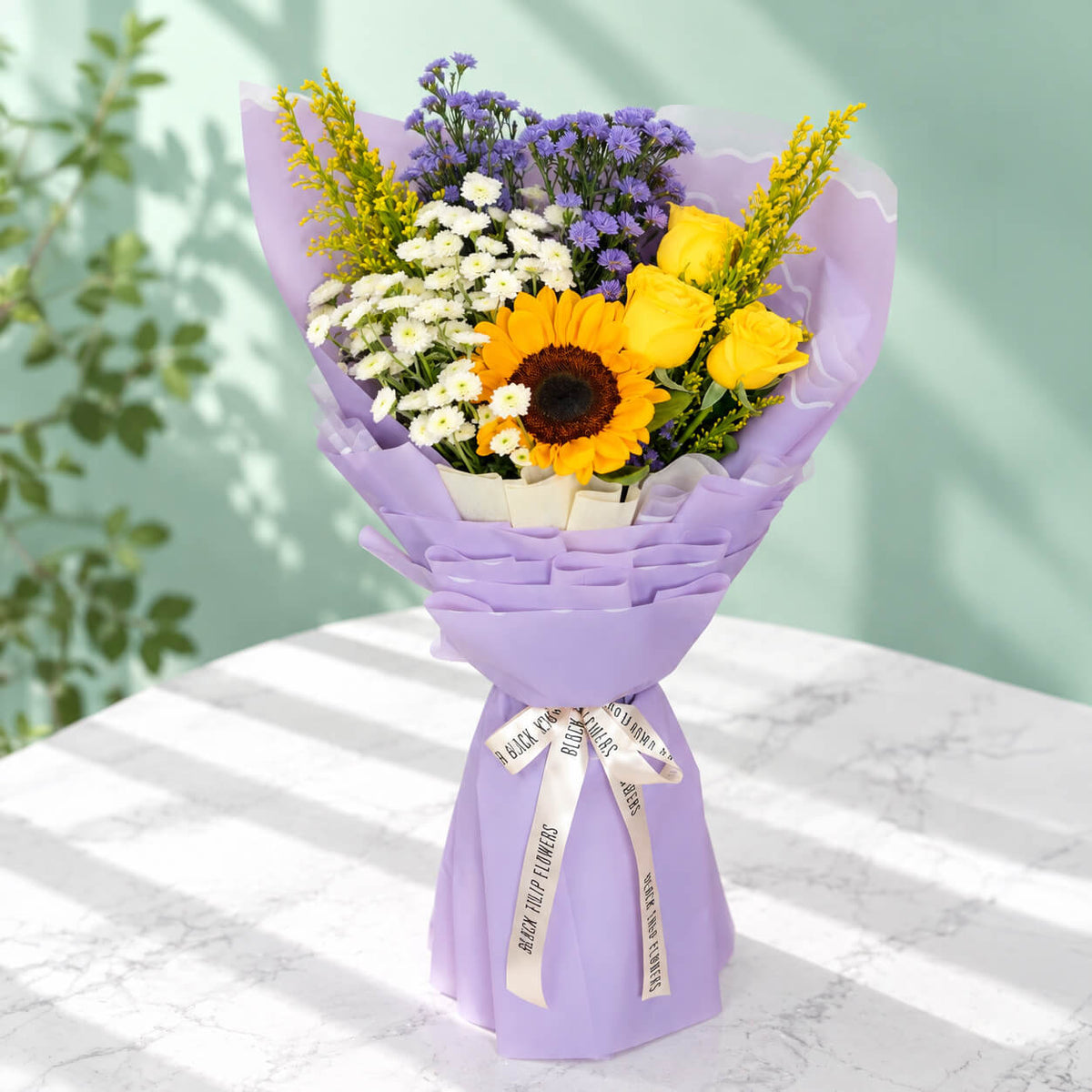10-stem assorted flower bouquet featuring sunflowers, chrysanthemums, roses, daisies and goldenrod, wrapped in Korean-style flower wrapping sheets.