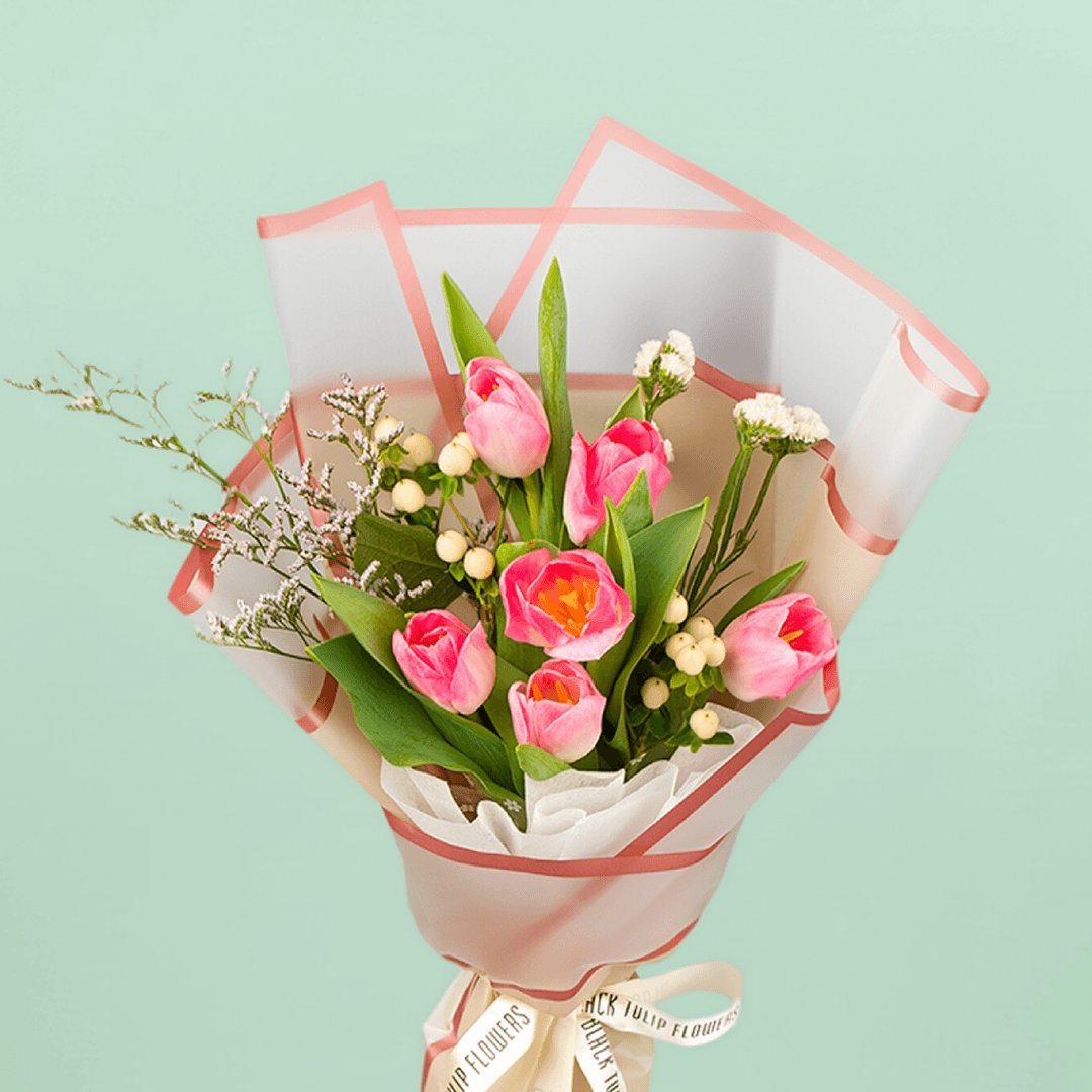 Pink tulips with Hypericum and greenery wrapped in Korean-style flower sheets.