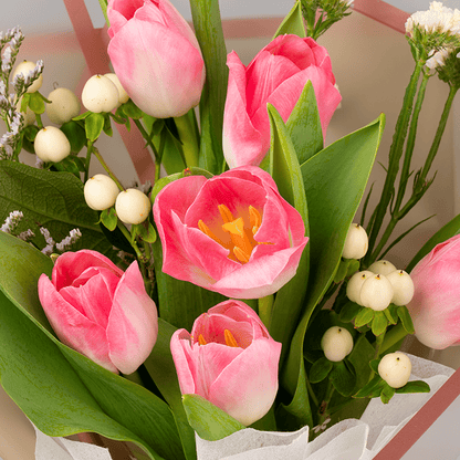 Pink tulips with Hypericum and greenery wrapped in Korean-style flower sheets.