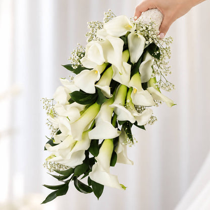 White calla lily with delicate gypsophila flowers arranged in a minimalist hand-tied wrap.