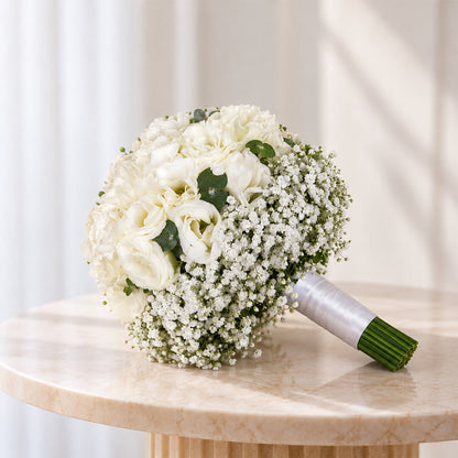 Elegant white hydrangea bridal bouquet featuring eustoma, gypsophila, and eucalyptus in a clean minimalist hand-tied stem wrap.