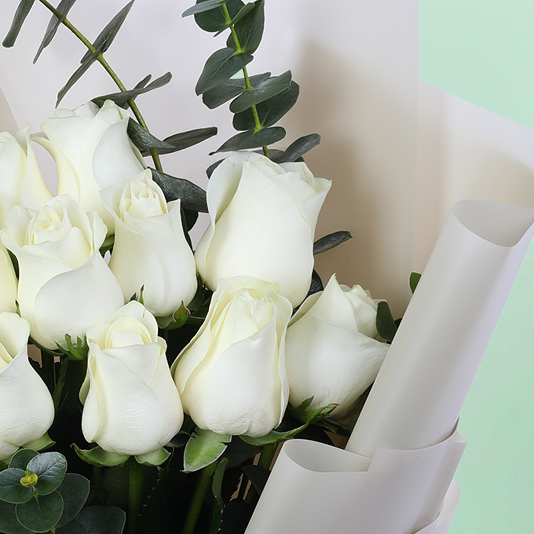 10 White Rose Eucalyptus Bouquet arranged with 10 white roses and eucalyptus