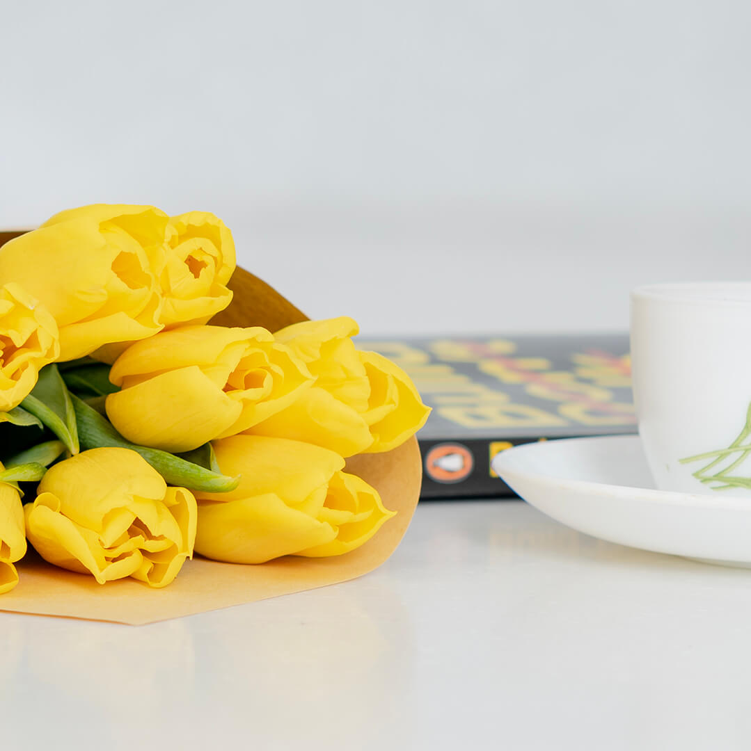 Fresh yellow cut tulip flowers with bright golden petals in a spring bouquet