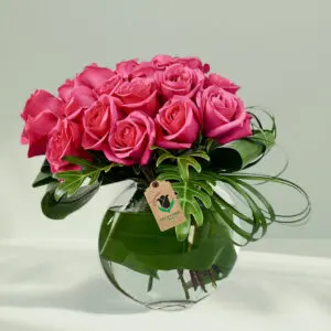 20 to 25 Pink rose in Glass vase with foilage