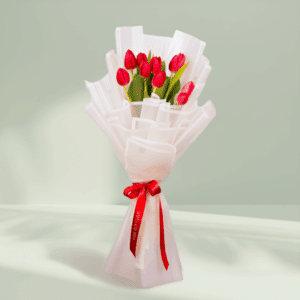 10 red tulips bouquet wrapped in white Korean flower paper with red satin ribbon