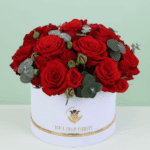 Valentine’s Day red roses with eucalyptus arranged in a luxury white flower box.