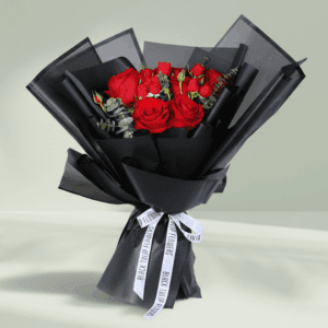 "Red roses with delicate spray roses and eucalyptus, wrapped in elegant black Korean-style flower sheets"