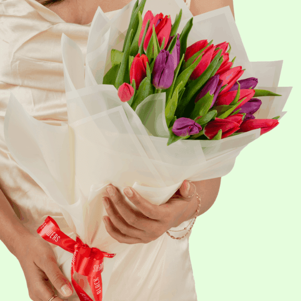 Pink and Purple tulip bouquet is wrapped in a white Korean-style wrapping sheet