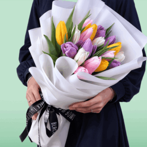 Fresh assorted tulip bouquet featuring 20 colorful stems wrapped beautifully in a non-woven floral paper.
